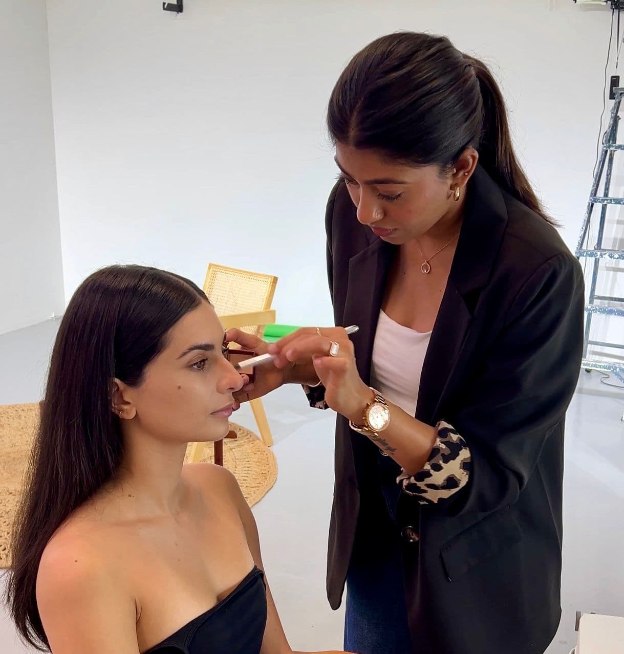 Sheetal applying makeup on set
